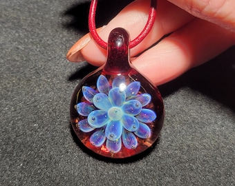 Boro Implosion pendant hand blown glass with a red base with a sparkly blue lotus flower Implosion design in borosilicate glass!