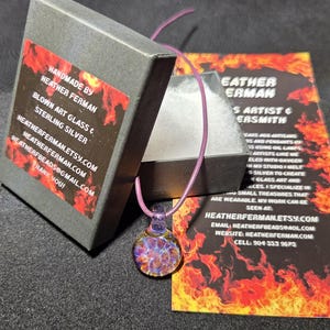 Image of the pendant and a jewelry box labeled with the business name. A business bookmark explains the glassmaking process, accompanying the pendant for a complete gift presentation.