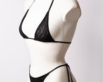 May include: Black mesh bikini top and bottom with thin straps. The top is a triangle style and the bottom is a thong style.