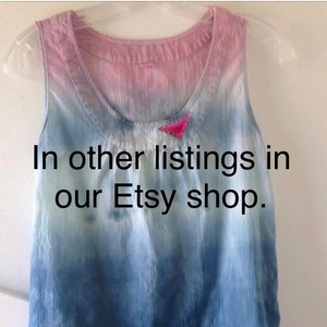 May include: A blue and pink tie-dye tank top with a small pink triangle sewn on the front. The text "In other listings in our Etsy shop." is printed on the front of the tank top.