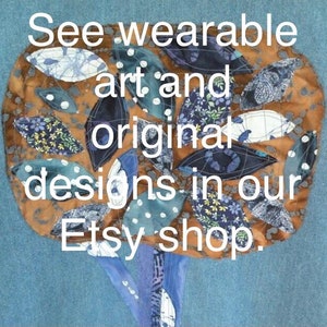 May include: A brown fabric tree with blue and white patterned leaves. The text "See wearable art and original designs in our Etsy shop." is written on the tree.