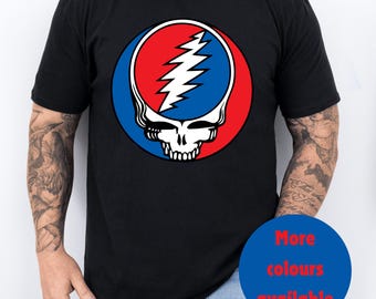 May include: A black t-shirt with a red, white, and blue graphic of a skull with a lightning bolt. The text "More colours available" is in a blue circle.