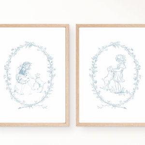 May include: Two framed prints with a blue and white illustration of a girl and a lamb in a wreath of flowers.
