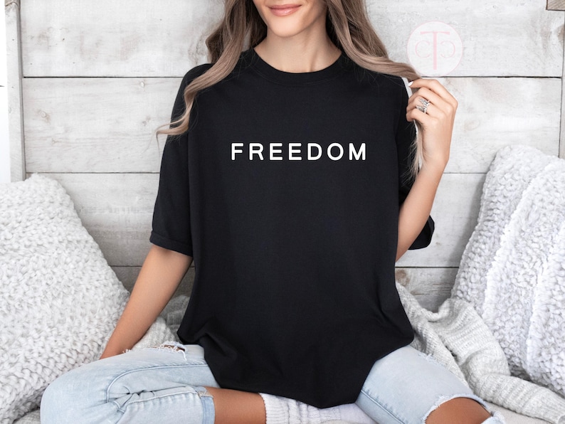 We the People patriotic shirt with bold FREEDOM graphic, unisex activist t-shirt.

Free speech graphic tee featuring simple bold FREEDOM design, Gildan unisex shirt.
