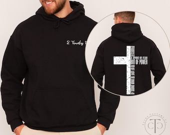 May include: Black hoodie with a front pocket and drawstring. The front features the text "2 Timothy 1:7" in white. The back displays a white cross with the text "FOR GOD HAS NOT GIVEN US A SPIRIT OF FEAR BUT OF POWER AND OF LOVE AND OF SOUND MIND."