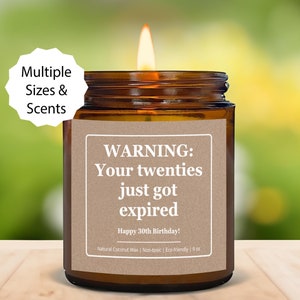 May include: A brown glass candle jar with a white label that reads "WARNING: Your twenties just got expired. Happy 30th Birthday!"  Natural Coconut Wax | Non-toxic | Eco-friendly | 9 oz.