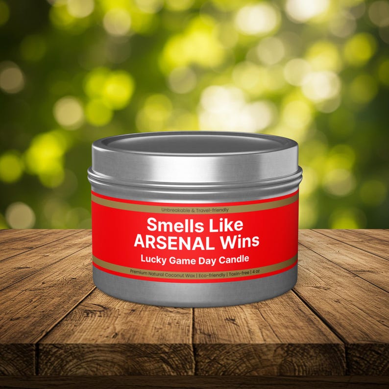 Wonderscape Wicks candle shop on Etsy presenting closed 4 oz tin candle with text smells like Arsenal Wins Lucky Game Day Candle held by a woman on a lifestyle background. The all natural cotton-wick candle can be personalized with customer's custom text. The design is aimed at Premier League Football Soccer fans with Arsenal red and white colors. Gift for wife boyfriend husband girlfriend brother sister Bukayo Saka Martin Odegaard Declan Rice Gabriel Martinelli Thierry Henry Dennis Bergkamp