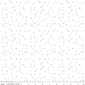 May include: A white fabric featuring a repeating pattern of small red stars, tiny red dots, and light blue floral sprigs. A ruler at the bottom shows a scale of 12 inches, indicating the print size and spacing of the scattered design elements.