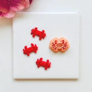 May include: A white ceramic mug with a black handle and the text "But First, Coffee" in a handwritten style. The mug is on a white surface. The mug is 10 cm tall.