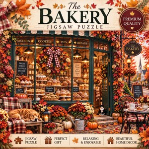 May include: A jigsaw puzzle box featuring a bakery storefront decorated with autumn leaves, pumpkins, and flowers. The text reads The Bakery Jigsaw Puzzle, Premium Quality, and includes labels for pastries, cookies, pies, and breads.