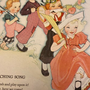 May include: Four children dressed in colorful costumes are playing music. A girl in a white dress and hat holds a sword, a boy in a plaid hat plays a drum, a boy in a black sweater plays a tambourine, and a girl in a pink dress holds a flag.