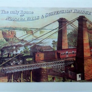May include: A vintage travel poster advertising the "The only Route to Niagara Falls & Suspension Bridge". The poster features a train crossing a suspension bridge over a river with Niagara Falls in the background.