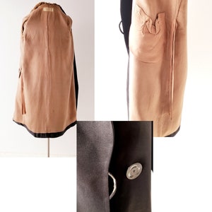 May include: A black wool coat with a brown fur collar and lining. The coat has a button closure and a single pocket on the left side. The lining is visible in the back and the pocket is visible on the right side.