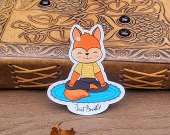 May include: A sticker featuring a cartoon fox in a yoga pose on a blue mat with the text "Just Breathe!"