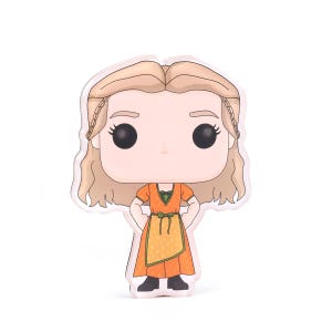 Peut inclure: Figurine Funko Pop en vinyle représentant un personnage aux cheveux blonds, vêtu d'une robe orange avec un tablier jaune. La figurine a des yeux noirs et est posée avec les mains sur les hanches. Objet de collection.