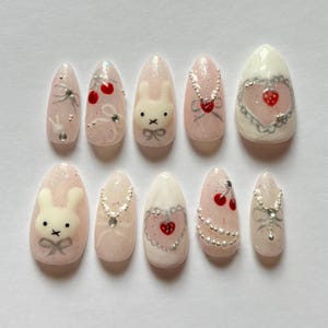 custom press on nails, cute pink and white Miffy and berries press on nails with hearts and gems