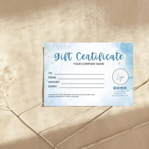 May include: A blue and gold gift certificate template with the text "gift Certificate" and "Your Company Name". The template has space for the recipient's name, the sender's name, the amount of the gift certificate, and the expiration date. There is also a logo placeholder and contact information.