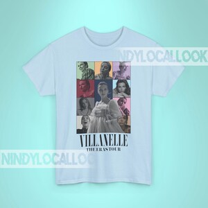 May include: Light blue t-shirt with a collage of images of a woman in a white dress and other people. The text "Villanelle The Eras Tour" is printed on the shirt.