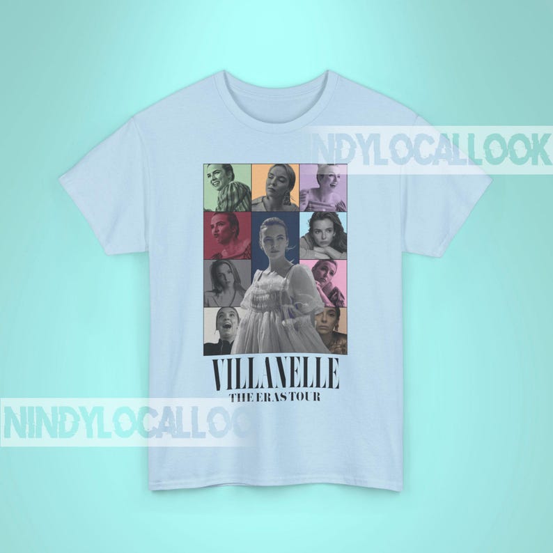 May include: Light blue t-shirt with a collage of images of a woman in a white dress and other people. The text "Villanelle The Eras Tour" is printed on the shirt.