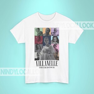 May include: White t-shirt with a collage of images of a woman in a white dress and other people. The text "Villanelle The Eras Tour" is printed below the collage.