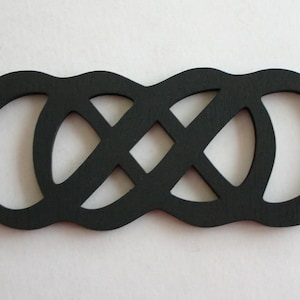 May include: Black wooden cutout of an infinity symbol, a continuous loop design.
