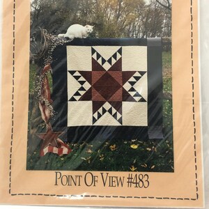 May include: A Country Threads pattern packet in a clear plastic sleeve. The packet features a quilt design with a star pattern in shades of red, cream, and black. The text "Point of View #483" is visible.
