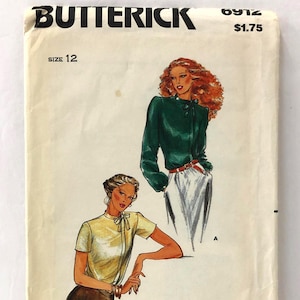 May include: Vintage Butterick sewing pattern envelope. The envelope is off-white with illustrations of two women wearing the clothing designs. The text "Butterick" is at the top, with "Size 12" and the price printed on the front.
