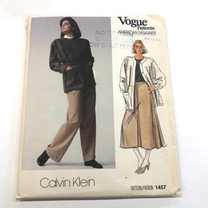 May include: A vintage Vogue Patterns sewing pattern featuring designs by Calvin Klein. The cover displays illustrations of two outfits: a jacket and pants ensemble, and a jacket and skirt combination. The pattern number is 1457.