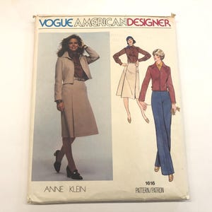 May include: A vintage Vogue American Designer sewing pattern featuring a woman in a skirt suit and two other outfits. The pattern is labeled "ANNE KLEIN" and includes the number "1616". The cover has a cream-colored background.