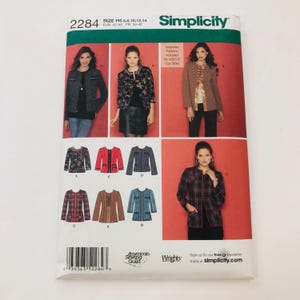 May include: Simplicity sewing pattern number 2284 for a jacket. The pattern includes sizes H5 6, 8, 10, 12, 14, EUR 32-40, FR 34-42. The pattern shows five different versions of the jacket, including a black and white tweed jacket, a floral print jacket, a brown jacket, a red and black plaid jacket, and a blue denim jacket. The pattern also includes a separate pattern for cup sizes A, B, C, and D.