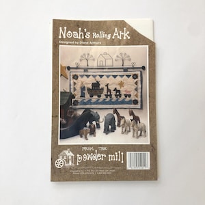 May include: A craft pattern titled "Noah's Rolling Ark" designed by Diane Arthurs. The cover features a detailed illustration of Noah's Ark with various animal figures. The words "FROM THE powder mill" are also visible.