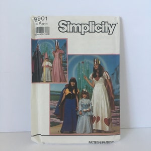 May include: Simplicity sewing pattern number 9901 for a Wizard of Oz costume. The pattern includes a dress for a woman and two dresses for girls. The pattern is for sizes 2-7.