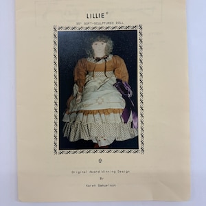 May include: A vintage sewing pattern for a 35 inch soft-sculptured doll named Lillie. The pattern features a color photo of the doll wearing a brown and white dress with a purple ribbon. The pattern is titled "Original Award Winning Design by Karen Samuelson."