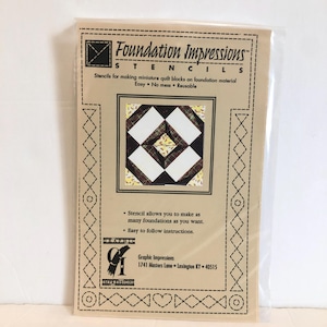 May include: A Foundation Impressions stencil for making miniature quilt blocks. The stencil is reusable and easy to use. The image shows a quilt block with a black, white, and brown plaid pattern.