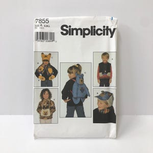 May include: Simplicity sewing pattern 7855. The pattern features children's clothing designs, including a bear-themed hat, scarf, mittens, vest, backpack, and cap. The pattern size is A, S, M, and L.