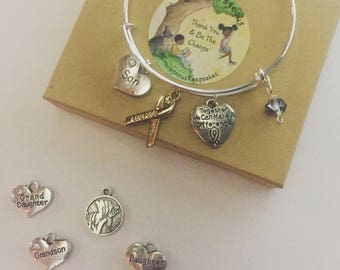 Silver plated Childhood Cancer Awareness bangle with 3 charms and a clear crystal bead.