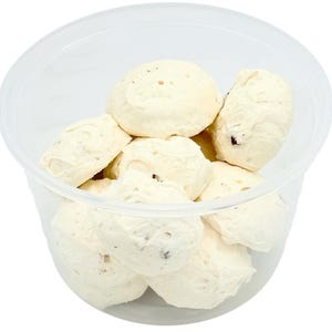 May include: A clear plastic container filled with white meringue cookies. The cookies are round and have a slightly rough texture.
