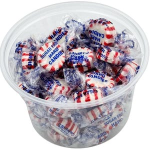 May include: A clear plastic container filled with red and white striped hard candies. The candies are wrapped in individual clear wrappers with blue text that reads "Sugar Free Hard Candies".