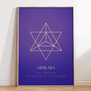 May include: A framed print with a purple background and a gold geometric star shape in the center. The text "MERKABA" is below the star shape, and the text "Sacred Vehicle of Ascension" is below that.