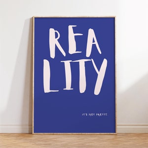 May include: A framed print with a blue background and the word "REALITY" written in pink. The text "IT'S NOT PRETTY." is written in white below the word "REALITY".