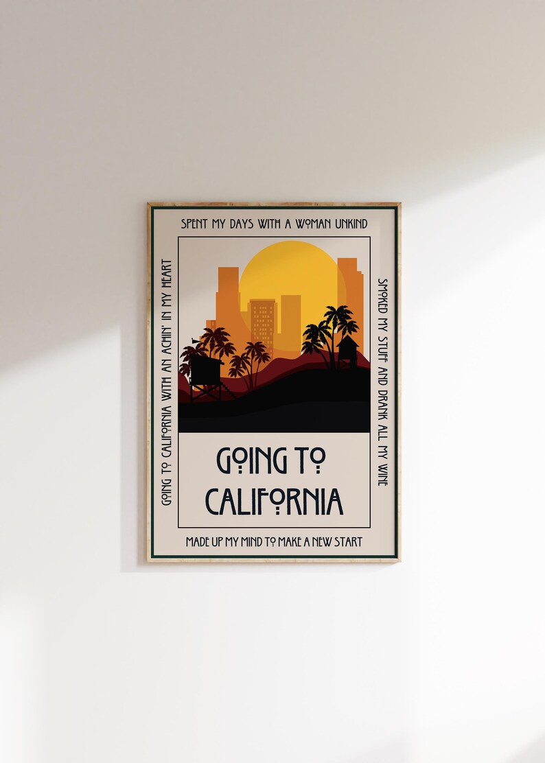 May include: A framed art print with a retro design. The artwork features a sunset over a city skyline with palm trees. The text "Going to California" is prominently displayed, along with other phrases.