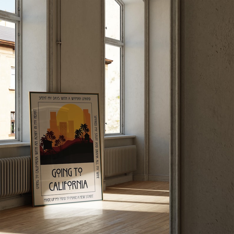 May include: A framed poster with the text "Going to California" and a sunset graphic with palm trees and city silhouettes. The poster is leaning against a wall near a window, with the text "Spent my days with a woman unwind" and "Smoked my stuff and drank all my wine".