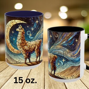 May include: A white ceramic mug with a black interior and a colorful illustration of a llama standing in front of a crescent moon and stars. The mug is 15 ounces.