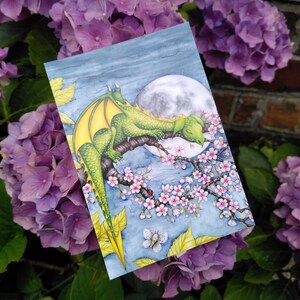 Carte postale Dragon endormi - oeuvre d'art fantastique enchanteur avec fleurs de cerisier et pleine lune