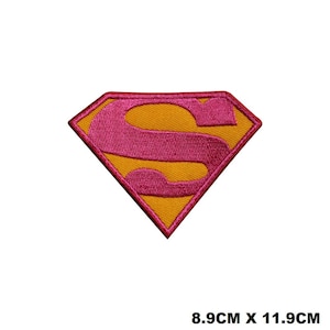 May include: A yellow and pink Superman logo iron-on patch, measuring 8.9 cm by 11.9 cm.