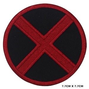 May include: Red embroidered X on a black circular patch. The patch is 7.7 cm in diameter.