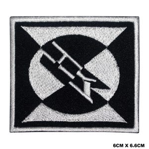 May include: Black and white embroidered patch with a stylized image of a rocket ship in a circle. The patch is 6 cm by 6.6 cm.