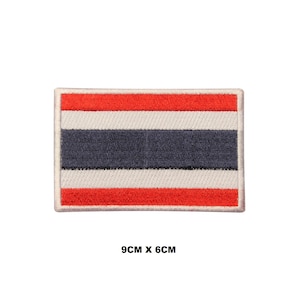 May include: A red, white, and blue embroidered patch of the Thai flag. The patch is 9 cm by 6 cm.