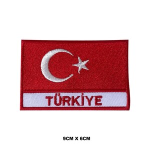 May include: A red embroidered patch with a white crescent moon and star, and the word "TÜRKİYE" in white lettering. The patch is 9 cm by 6 cm.