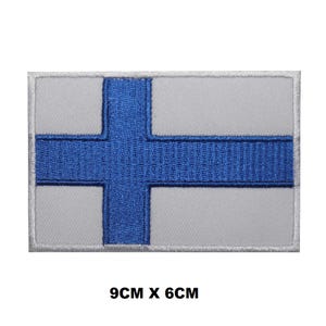 May include: Embroidered patch of the Finnish flag. The flag is white with a blue cross. The patch is 9 inches by 6 inches.